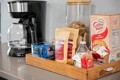a wooden tray filled with food on a counter at Pickle Factory Hotel - 8BR Full Hotel with Free Parking in Covington