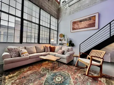 a living room with a couch and some windows at New renovated Loft in Old factory by Kings Island in Maineville