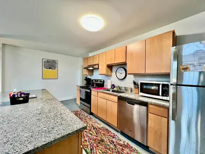 a kitchen with wooden cabinets and a stainless steel refrigerator at New renovated Loft in Old factory by Kings Island in Maineville