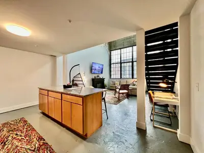 a kitchen with a island in the middle of a room at New renovated Loft in Old factory by Kings Island in Maineville