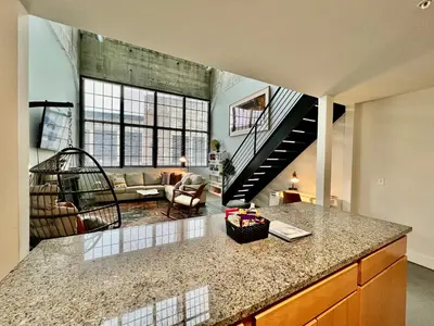 a kitchen with a counter top and a living room at New renovated Loft in Old factory by Kings Island in Maineville