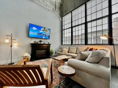 a living room with a couch and a fireplace at New renovated Loft in Old factory by Kings Island in Maineville