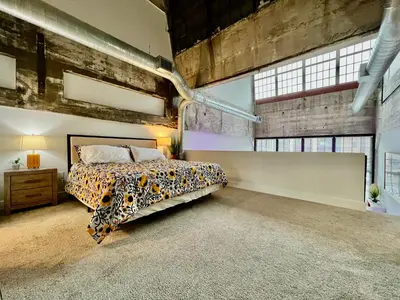 a bedroom with a leopard print bed in a loft at New renovated Loft in Old factory by Kings Island in Maineville