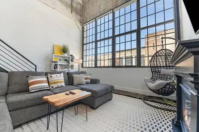 a living room with a couch and a table at The Coolest Loft in the Cincinnati Area in Maineville
