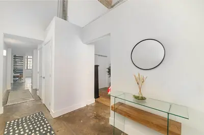 a hallway with a glass table and a mirror at The Coolest Loft in the Cincinnati Area in Maineville