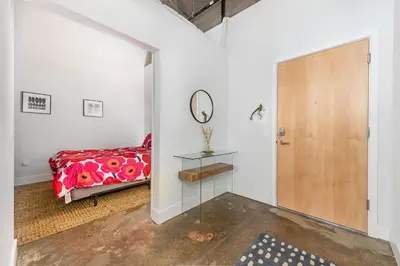 a bedroom with a bed and a mirror at The Coolest Loft in the Cincinnati Area in Maineville