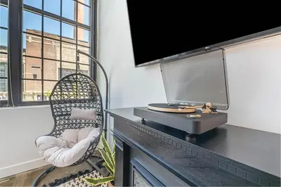 a room with a desk with a tv and a chair at The Coolest Loft in the Cincinnati Area in Maineville