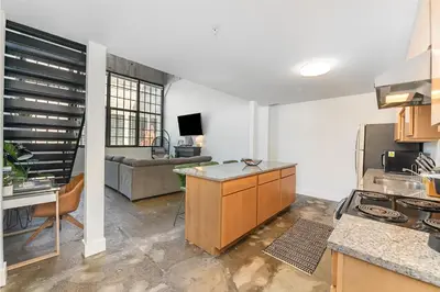 a kitchen with a table and a couch in a room at The Coolest Loft in the Cincinnati Area in Maineville