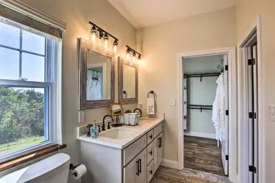a bathroom with a sink and a toilet and a window at Chic Williamstown Retreat with Pool and Hot Tub! in Williamstown