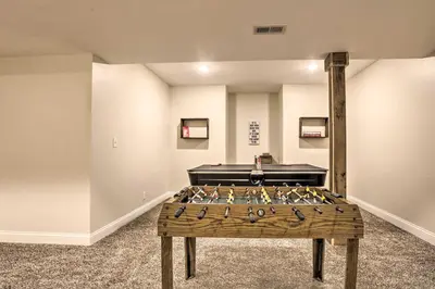 a game room with a foosball table in the middle at Chic Williamstown Retreat with Pool and Hot Tub! in Williamstown