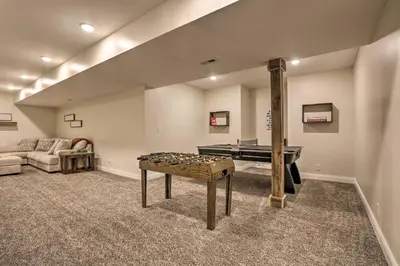 a living room with a ping pong table in the middle at Chic Williamstown Retreat with Pool and Hot Tub! in Williamstown