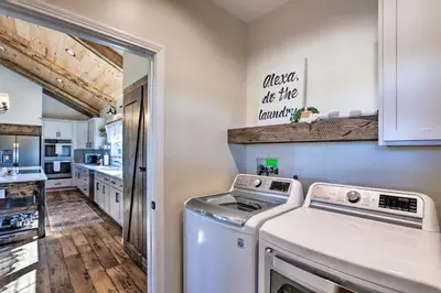 a laundry room with a washer and dryer at Chic Williamstown Retreat with Pool and Hot Tub! in Williamstown