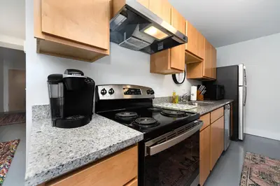 a small kitchen with a stove and a refrigerator at New Industrial Loft Space on River and Bike Trail in Maineville