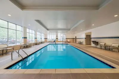 a swimming pool with blue water in a building at Hyatt Place Columbus Polaris in Columbus