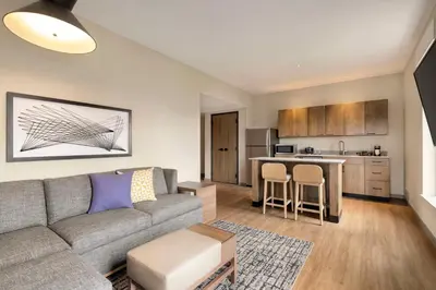 a living room with a couch and a kitchen at Hyatt Place Columbus Polaris in Columbus