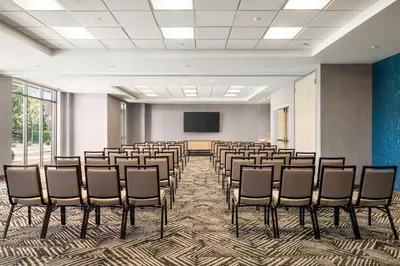 a conference room with chairs and a screen at Hyatt Place Columbus Polaris in Columbus