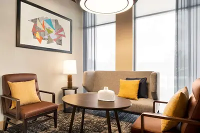 a living room with a couch and a table and chairs at Hyatt Place Columbus Polaris in Columbus