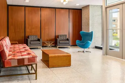 a waiting room with chairs and a blue chair at The Orbit Hotel, Trademark Collection by Wyndham in Fairview Park