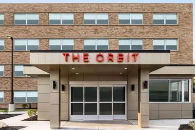 an office building with a sign that reads the oath at The Orbit Hotel, Trademark Collection by Wyndham in Fairview Park