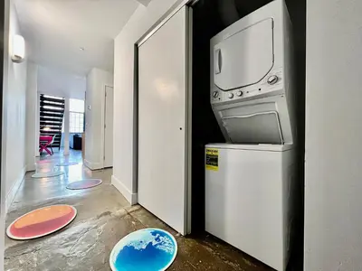 a kitchen with a stove and a washer and dryer at Kings Island Loft with Brewery, River, and Bike Trail in Maineville