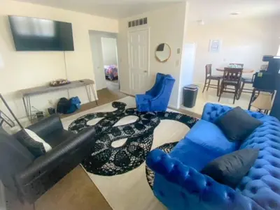a living room with a couch and blue chairs at Cozy Two Bedroom Apartment in the City Center in Trenton