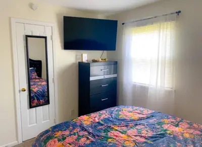 a bedroom with a bed and a flat screen tv at Cozy Two Bedroom Apartment in the City Center in Trenton
