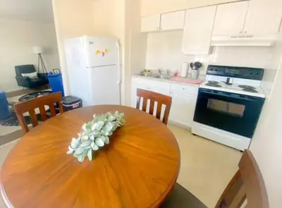 a kitchen with a wooden table with a flower on it at Cozy Two Bedroom Apartment in the City Center in Trenton