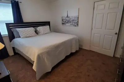a bedroom with a bed and a white door at Trenton's Apartment on First in Trenton
