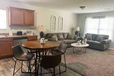 a living room with a couch and a table and chairs at Diamond in the Rough-696 in Middletown