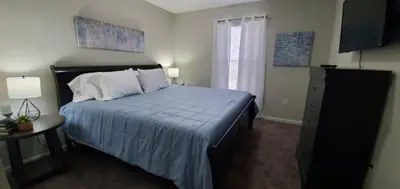 a bedroom with a bed with white pillows and a window at Diamonds are Forever-700 in Middletown