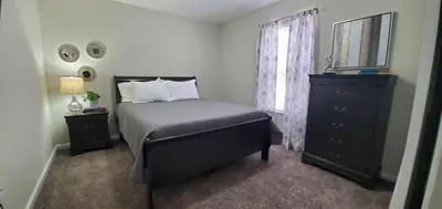 a bedroom with a bed and a dresser and a window at Diamonds are Forever-700 in Middletown