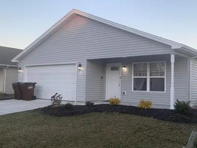 a white house with a white door and a yard at Diamonds are Forever-700 in Middletown