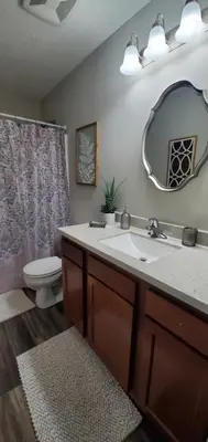a bathroom with a sink and a toilet and a mirror at Diamonds are Forever-700 in Middletown