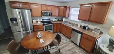 a kitchen with wooden cabinets and a wooden table at Diamonds are Forever-700 in Middletown