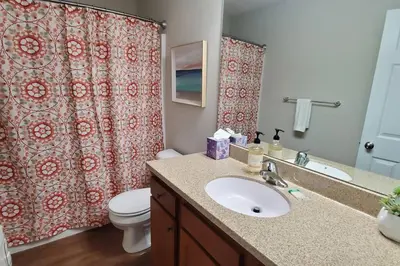 a bathroom with a sink and a toilet and a shower curtain at Diamond in the Sky-704 in Middletown
