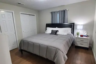 a bedroom with a large bed with a nightstand and a bed sidx sidx sidx at Diamond in the Sky-704 in Middletown