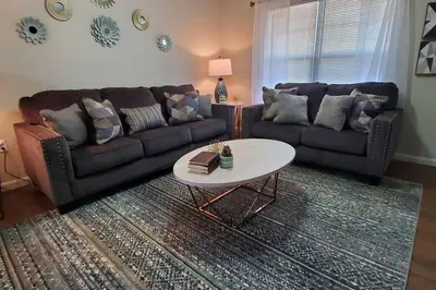 a living room with a couch and a table at Diamond in the Sky-704 in Middletown