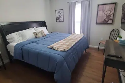 a bedroom with a bed with a blue blanket on it at Diamond in the Sky-704 in Middletown