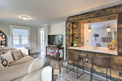 a living room with a couch and a kitchen at Pet-Friendly Home - half Mi to Downtown Willoughby! in Willoughby