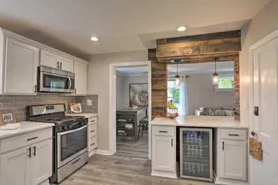 a kitchen with white cabinets and a stove top oven at Pet-Friendly Home - half Mi to Downtown Willoughby! in Willoughby