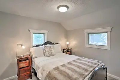 a bedroom with a bed and two windows at Pet-Friendly Home - half Mi to Downtown Willoughby! in Willoughby