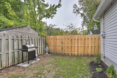 a backyard with a wooden fence and a grill at Pet-Friendly Home - half Mi to Downtown Willoughby! in Willoughby