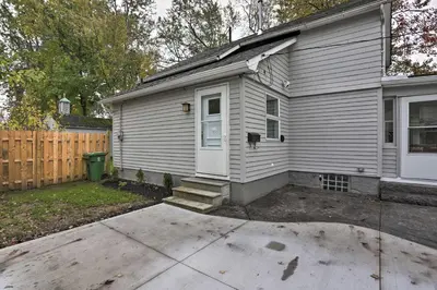 a white house with a white door and a yard at Pet-Friendly Home - half Mi to Downtown Willoughby! in Willoughby
