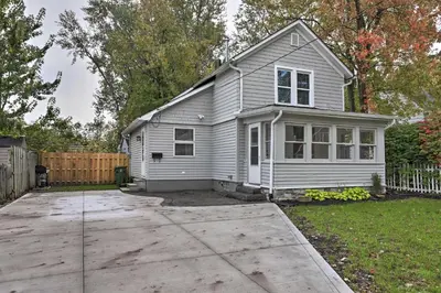a white house with a driveway in a yard at Pet-Friendly Home - half Mi to Downtown Willoughby! in Willoughby