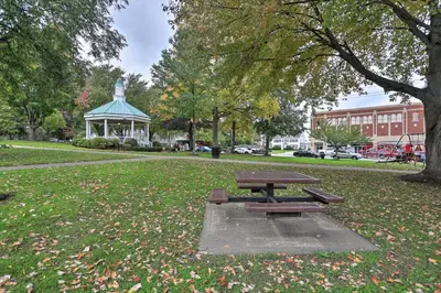 a picnic table in a park with a gazebo at Pet-Friendly Home - half Mi to Downtown Willoughby! in Willoughby