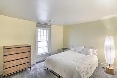 a bedroom with a bed and a dresser and a window at Historic Troy Home Close to Shops with Fire Pit in Troy