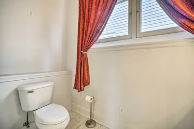 a bathroom with a toilet and a window at Historic Troy Home Close to Shops with Fire Pit in Troy