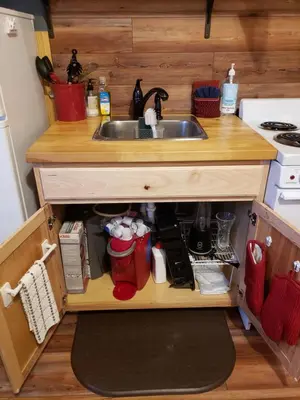 a kitchen with a sink and a stove at Acorn Cottage at Hocking Vacations in Logan