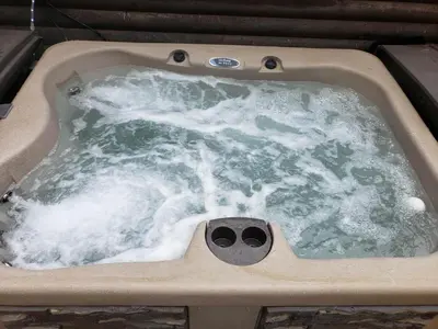 a jacuzzi tub with water in it at Acorn Cottage at Hocking Vacations in Logan
