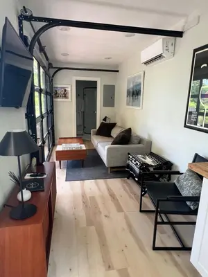 a living room with a couch and a table at The Hideaway on Tacketts - Shipping Container in Hurricane